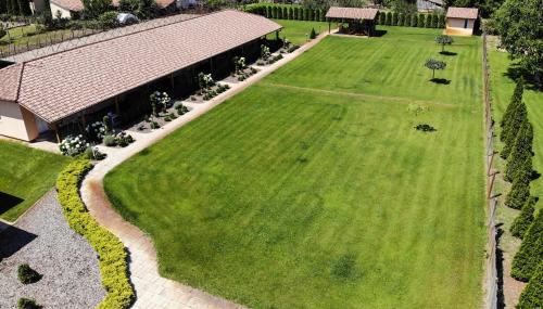 an aerial view of a large green yard with a building at Relax Apartmanház in Mórahalom