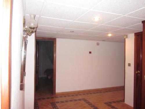 
a room with a door open and a rug in it at Hotel Elena María in Granada
