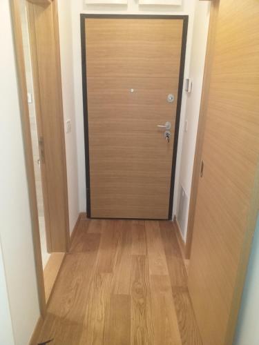 a door leading to a hallway with a wooden floor at MoonZe Gate in Belgrade