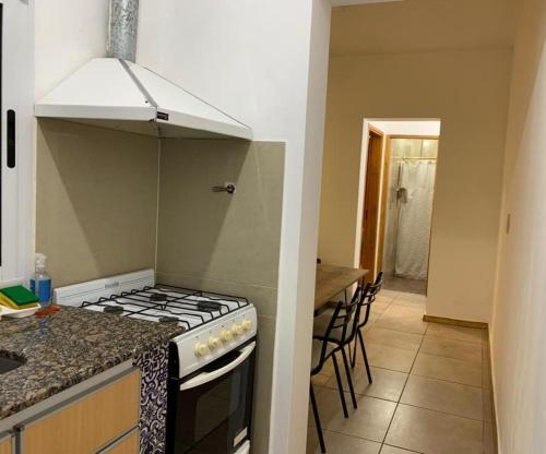 a kitchen with a stove and a counter top at Departamento en complejo residencial Villa Maria in Villa María
