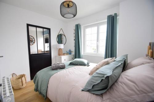 a bedroom with a large bed and a window at Vacances en mode piéton 2P 5mn plage Écluse in Dinard