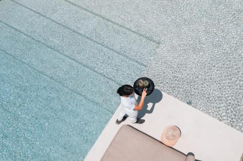 an overhead view of a child playing with a ball at Cove Paros in Naousa