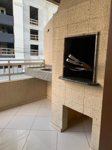 a fireplace in a building with a pen in it at Apto lindo e aconchegante próximo a praia in Itapema