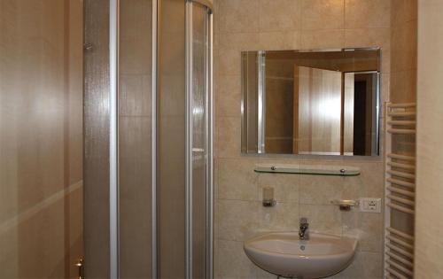 a bathroom with a sink and a mirror at Appartamenti Suttru in Badia