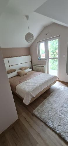 a bedroom with a large bed and a window at Apartments LaVu in Belgrade