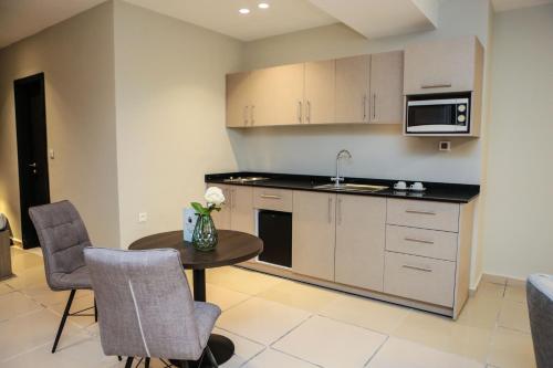 a kitchen with a small table and a microwave at Hôtel Ivotel Abidjan in Abidjan