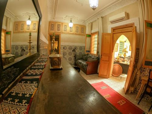 a living room with a large wooden table in it at Riad Inaka in Marrakech