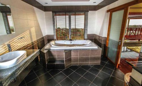 a large bathroom with a tub and a sink at Amazing Seaview Villa in Ko Lanta