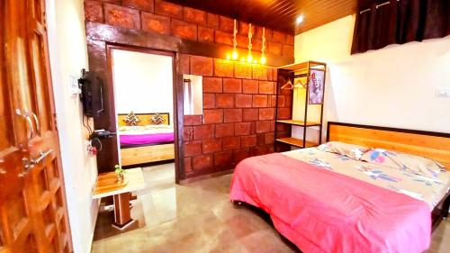 a small bedroom with a bed and a window at Dadaji Cottage, a unit of DADAJI VILLA in Panchgani