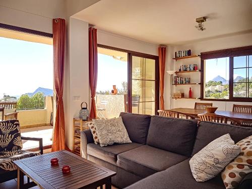 a living room with a couch and a table at Casa Altea Hills, Vista panorámica, Jacuzzi in Altea