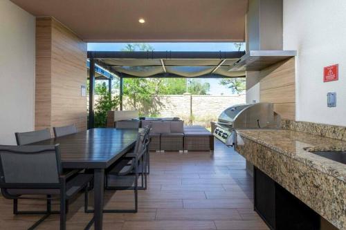 a kitchen and dining room with a table and chairs at Beautiful Magic Village 4 Suites near Disney 7493 in Orlando