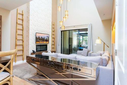 a living room with two white couches and a fireplace at Beautiful Magic Village 4 Suites near Disney 7493 in Orlando