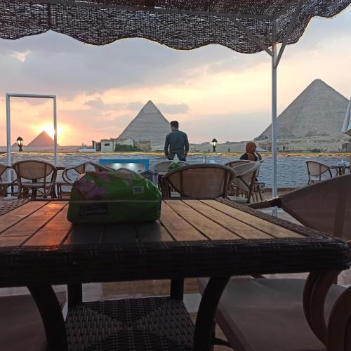 a picnic table in front of the pyramids at Pyramids Top Inn in Cairo