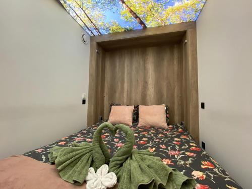 a bedroom with a bed with a large window at B&B Le Jardin de Sophie in Geraardsbergen