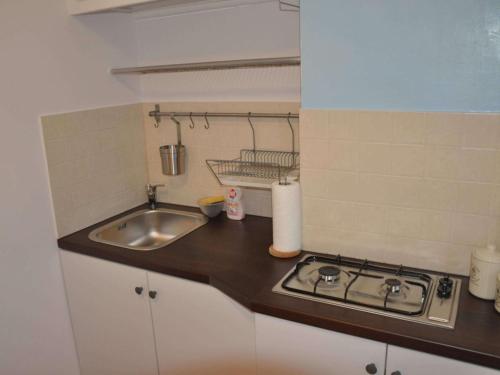 a small kitchen with a sink and a stove at Apartament z Widokiem in Gdynia