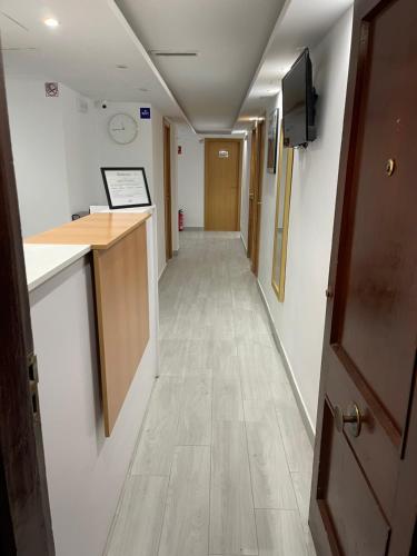 a hallway in a hospital with a hallwaygue at Hostal Portugal in Alicante