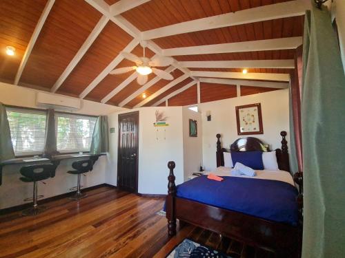 a bedroom with a bed and a wooden ceiling at Seaside Chateau Resort in Belize City