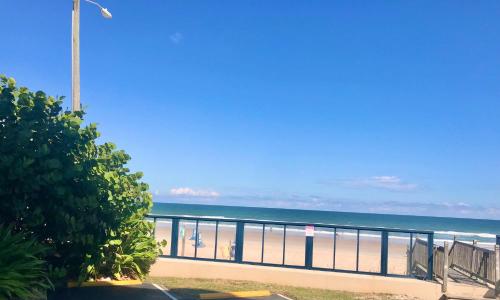 a view of the beach with a street light and the ocean at Ocean Waves - Ocean Front at Symphony Beach Club! in Ormond Beach