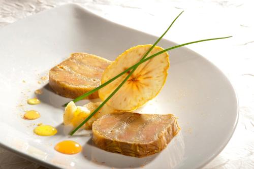 a plate of food with meat and eggs on it at Château des Monthairons Hôtel Restaurant GastroMaison Spa privatif in Les Monthairons