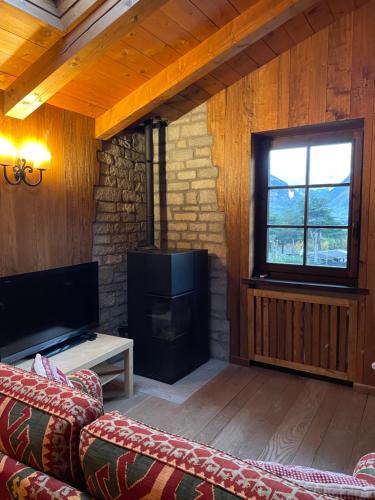 a living room with a couch and a fireplace at Appartamenti Espoire in La Salle
