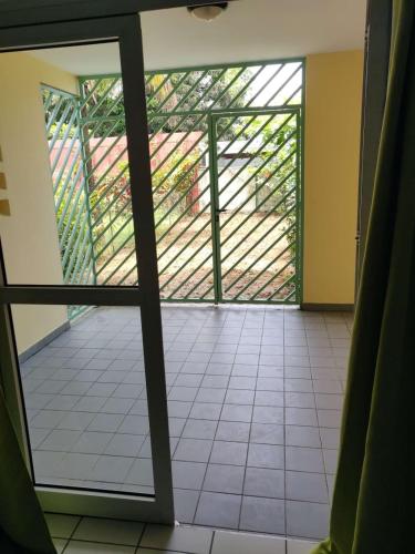 an open door to a room with a tiled floor at ST-Laurent Centre Confort T2 in Saint-Laurent du Maroni