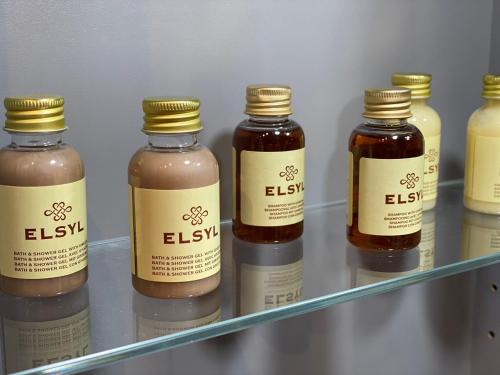 a row of honey bottles on a shelf in a refrigerator at Coach House @ The Booth in Hereford