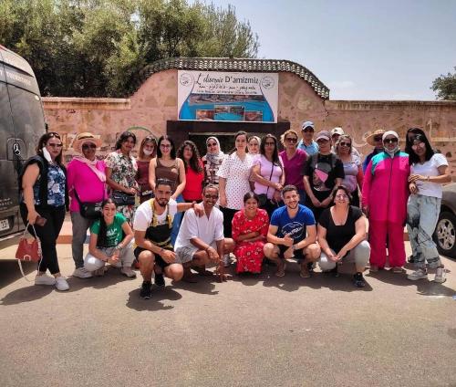 a group of people posing for a picture in front of a building at L'oliveraie D'amizmiz in Amizmiz