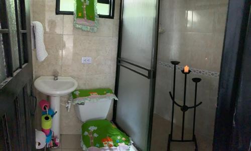 a small bathroom with a toilet and a sink at Hostel U in Bogotá