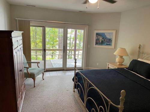 a bedroom with a bed and a sliding glass door at Main Channel Manor in Cadiz