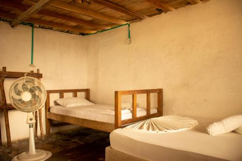 a room with two bunk beds and a fan at Dahlandia in Isla Mucura