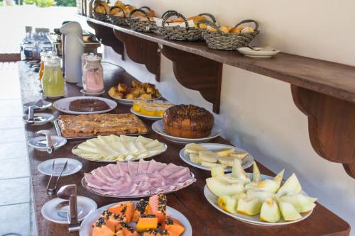 
a table topped with lots of different types of food at Hotel Villa Di Capri in Ubatuba

