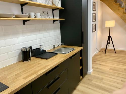 a kitchen with a sink and a counter top at Hotel, Apartament Pod Złotym Lwem w samym centrum miasta z DARMOWYM parkingiem VII in Kłodzko
