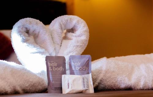 a pair of towels and a tube of hair and body products at Chikan Hoteles in Arequipa