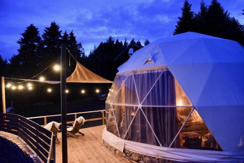a dome tent on a deck at night at Mountain tea in Pávliani