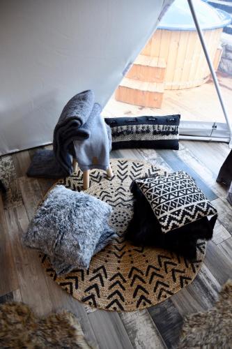 a bird standing on a rug in a room with pillows at Mountain tea in Pávliani