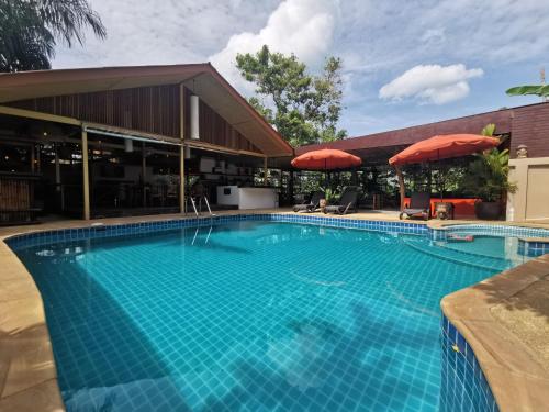 a large swimming pool in front of a building at Baan Sukreep Resort in Chaweng Noi Beach