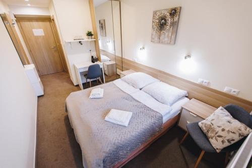 A bed or beds in a room at Penzión BEREA