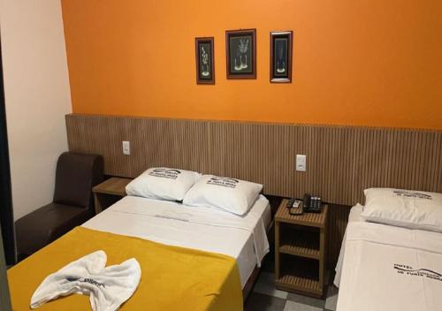 a hotel room with two beds with towels on them at Hotel Enseada de Ponta Negra in Natal