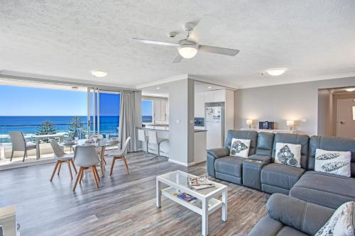 a living room with a couch and a table at Southern Cross Beachfront Holiday Apartments in Gold Coast