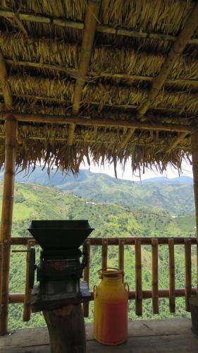 a large yellow pot sitting on a table in a thatch roof at Ecohotel Bordones in Isnos