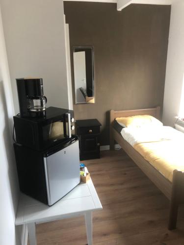 Kleines Zimmer mit einem TV und einem Bett. in der Unterkunft City Center Enschede Homestay in Enschede