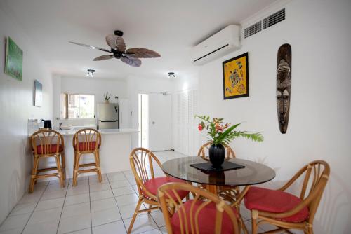 a kitchen and dining room with a table and chairs at Golden Sands Beachfront Resort in Yorkeys Knob