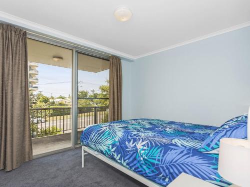 a bedroom with a bed and a balcony at Fairleigh Unit 1 in The Entrance