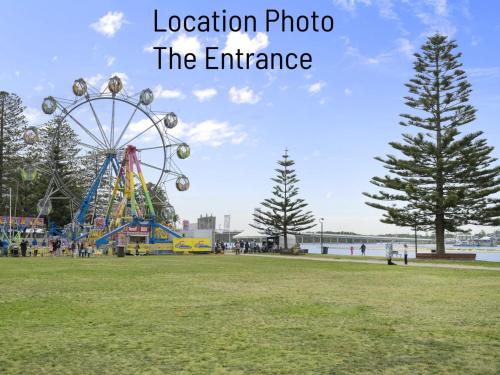 a ferris wheel in a park with the words location photo the entrance at Parklea Unit 9 in The Entrance