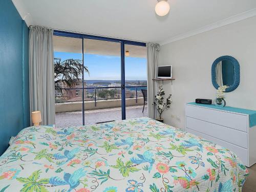 a bedroom with a bed and a view of the ocean at St Tropez Unit 39 in The Entrance
