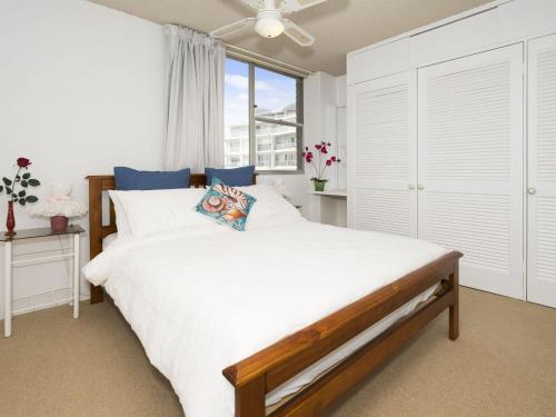 a bedroom with a large bed and a window at Tasman Towers Unit 13 in The Entrance