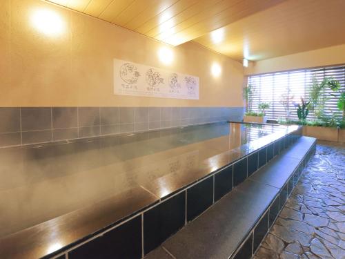 a waiting room with a long metal counter at Hotel Abest Grande Okayama in Okayama