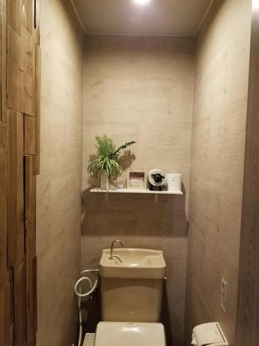 a bathroom with a toilet and a sink at ホテルLambie in Tōgane