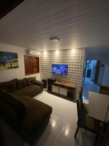 Télévision ou salle de divertissement dans l'établissement A casa miracles