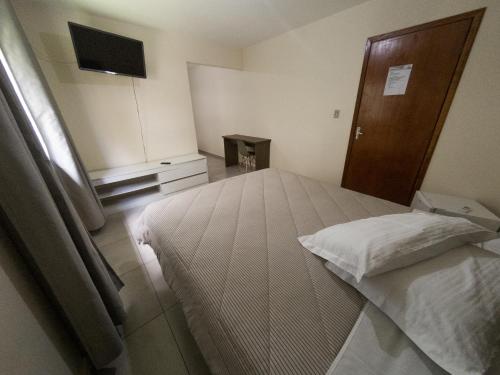 Ένα ή περισσότερα κρεβάτια σε δωμάτιο στο Nacional Park Hotel Lages